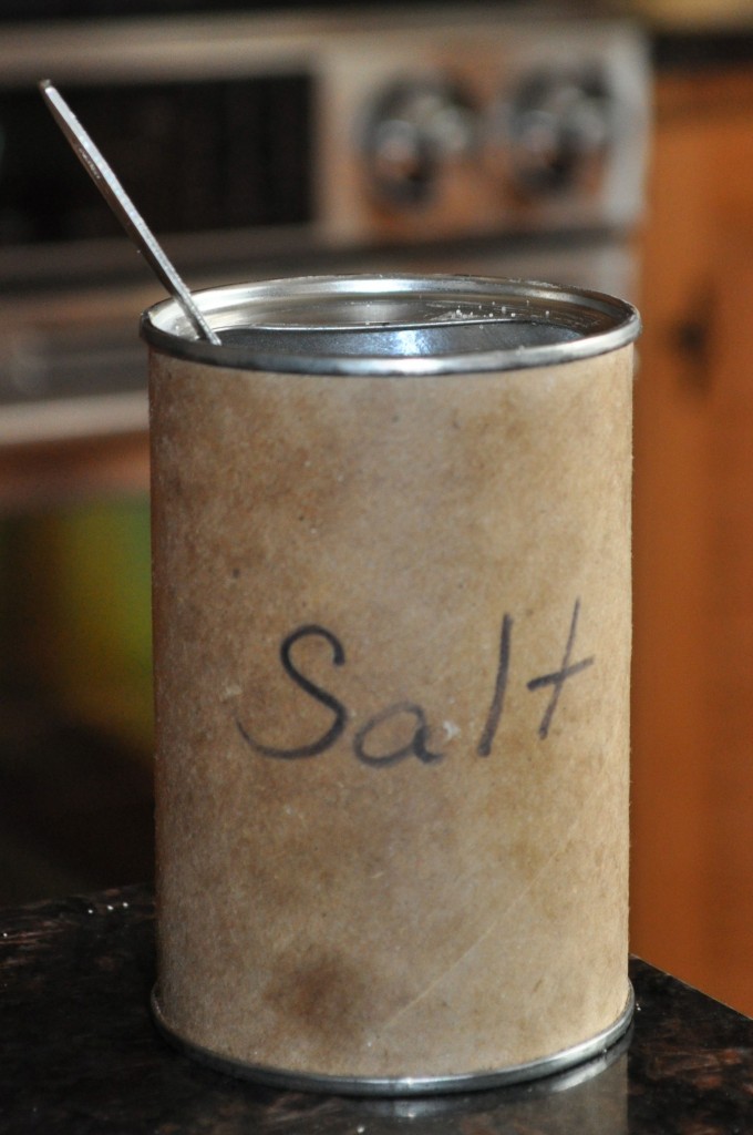 Put salt into an old baking powder can and leave a 1/2 tsp measuring spoon inside to simplify cooking.